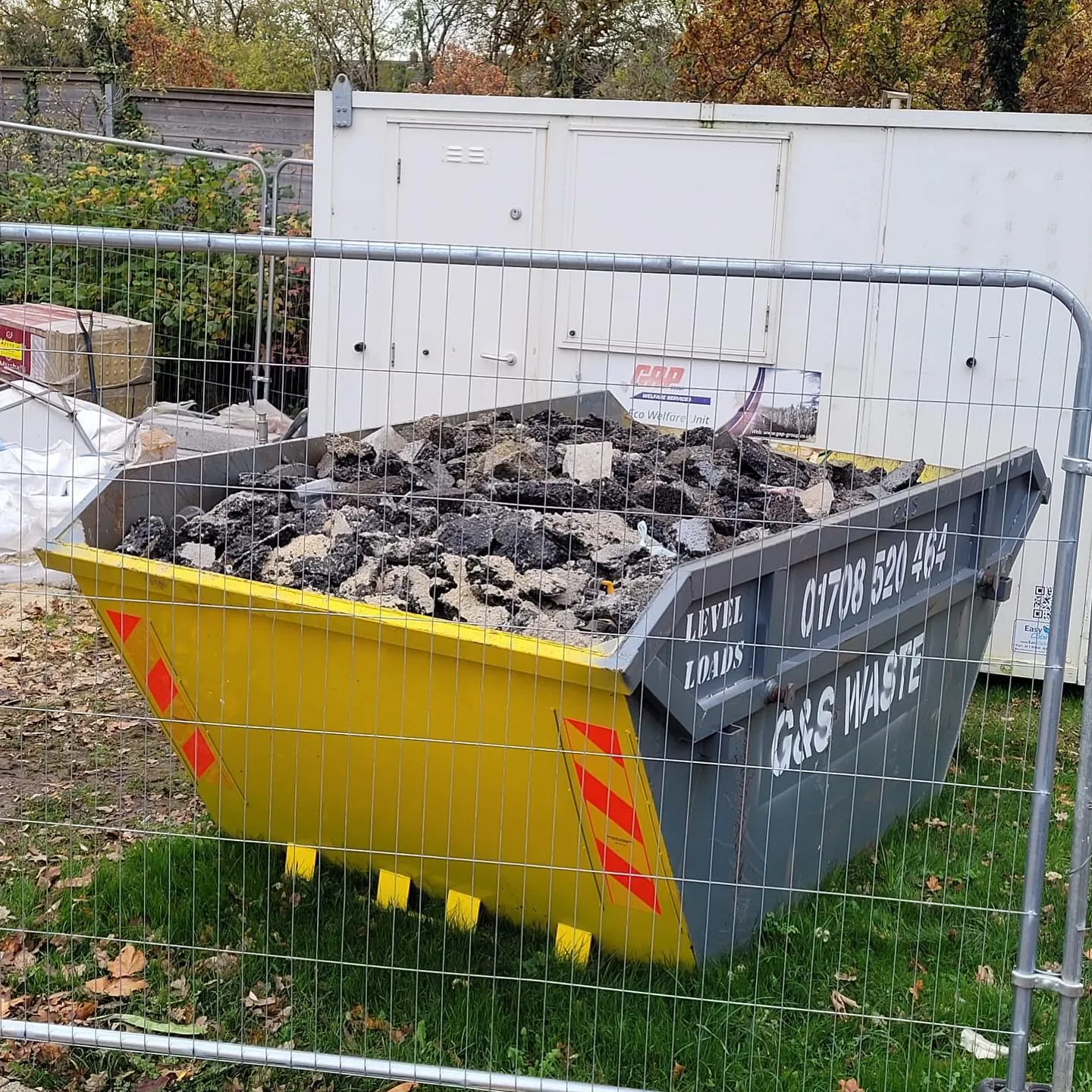 Skip behind fence